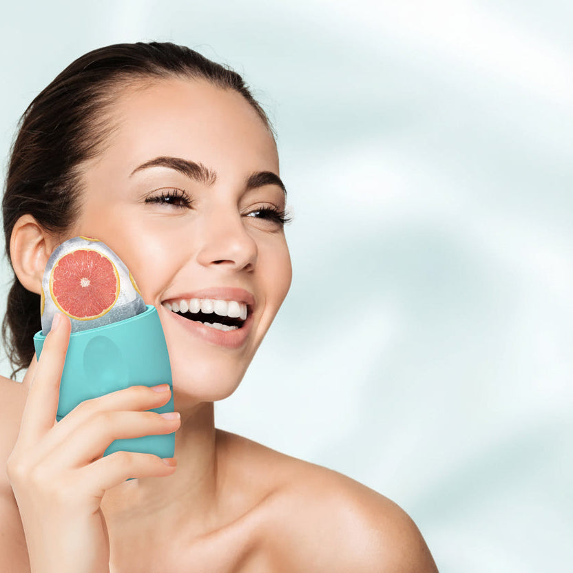 Woman using Aura Rituals CryoGlow™ silicone ice face roller for facial cooling and depuffing